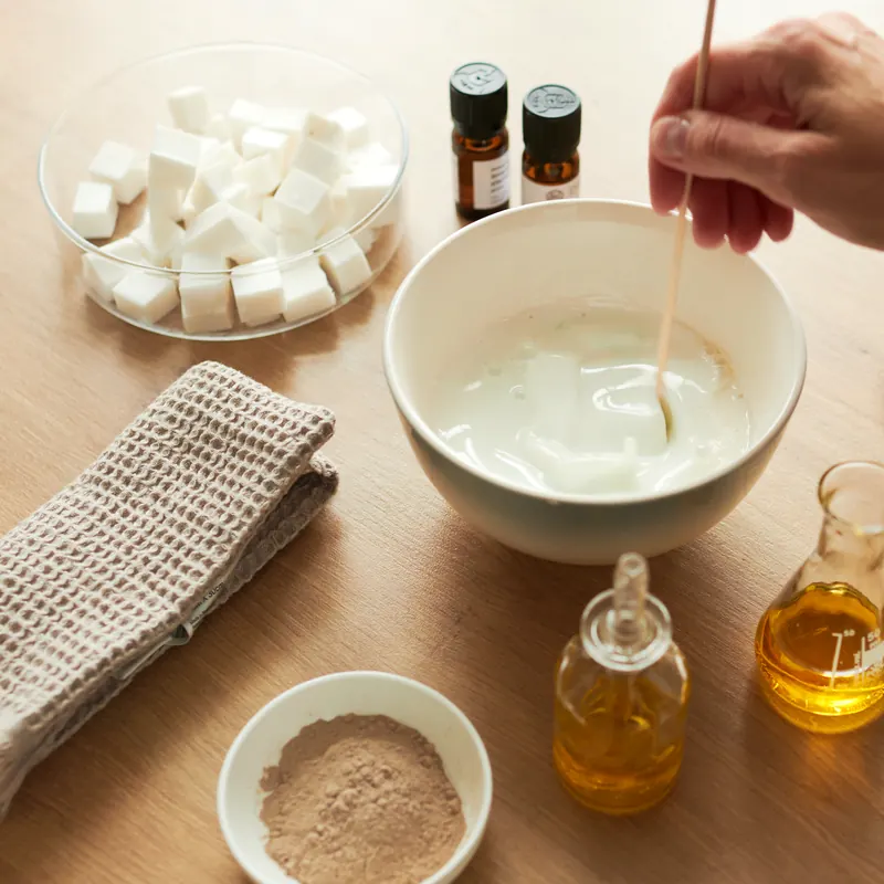 Stirring melted soap base in a bowl