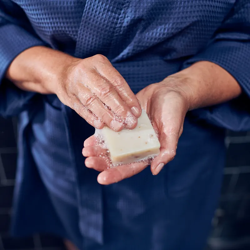 Hands holding a handmade goat milk bar