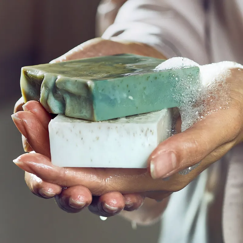 Hands holding two handmade bars
