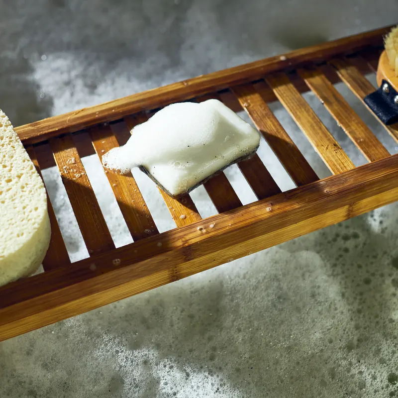 Lathered handmade bar on a bath tray