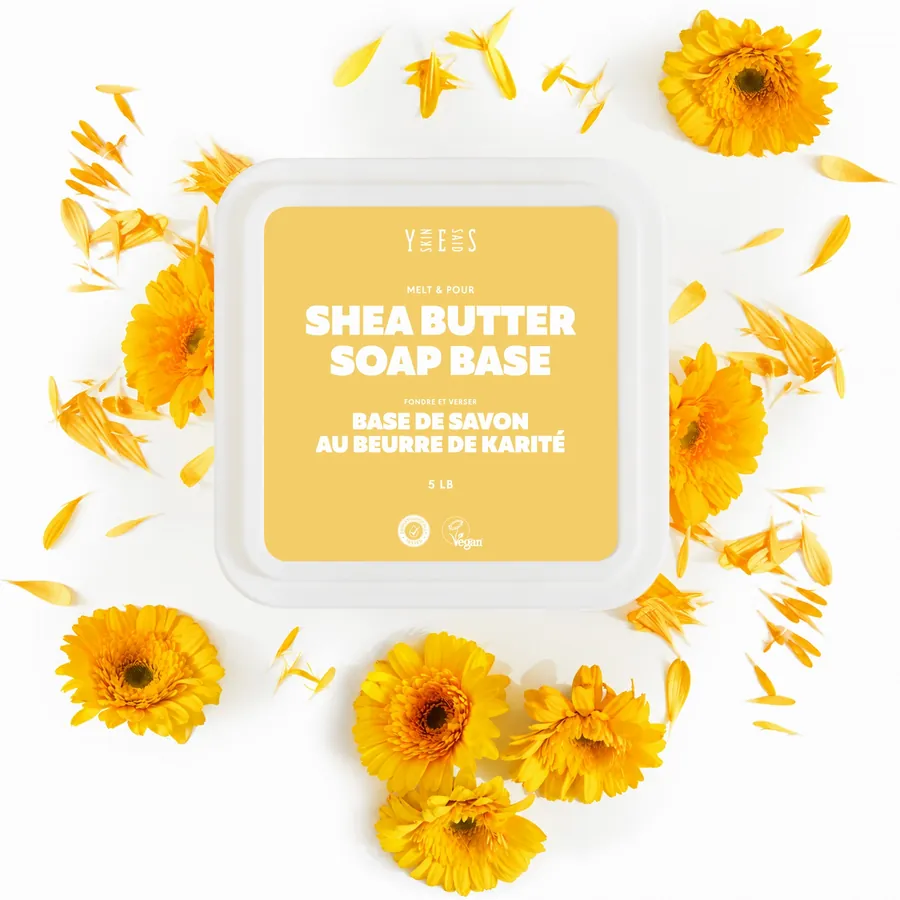 Shea butter soap base tub from above, with calendula flowers