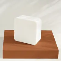 A block of cocoa butter soap base on a stand