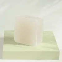 A clear block of glycerin soap base on a green stand
