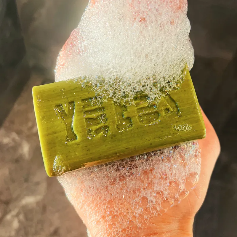 Hand lathering a Skin Said Yes olive oil soap bar